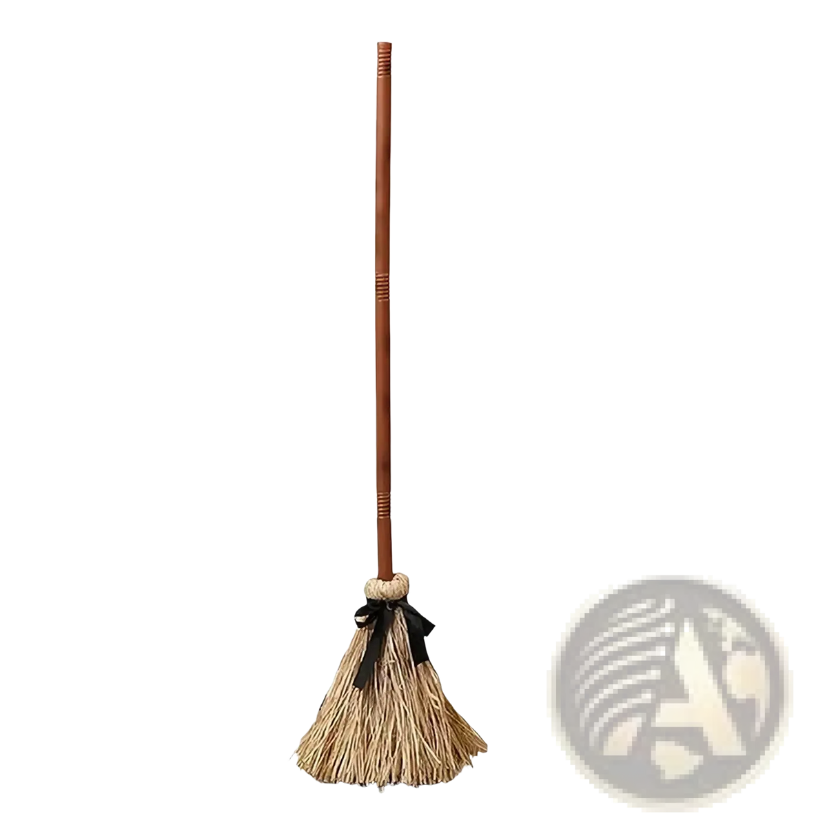 A rustic straw witch broom with wooden handle and black ribbon tie for animated sound activated Halloween décor