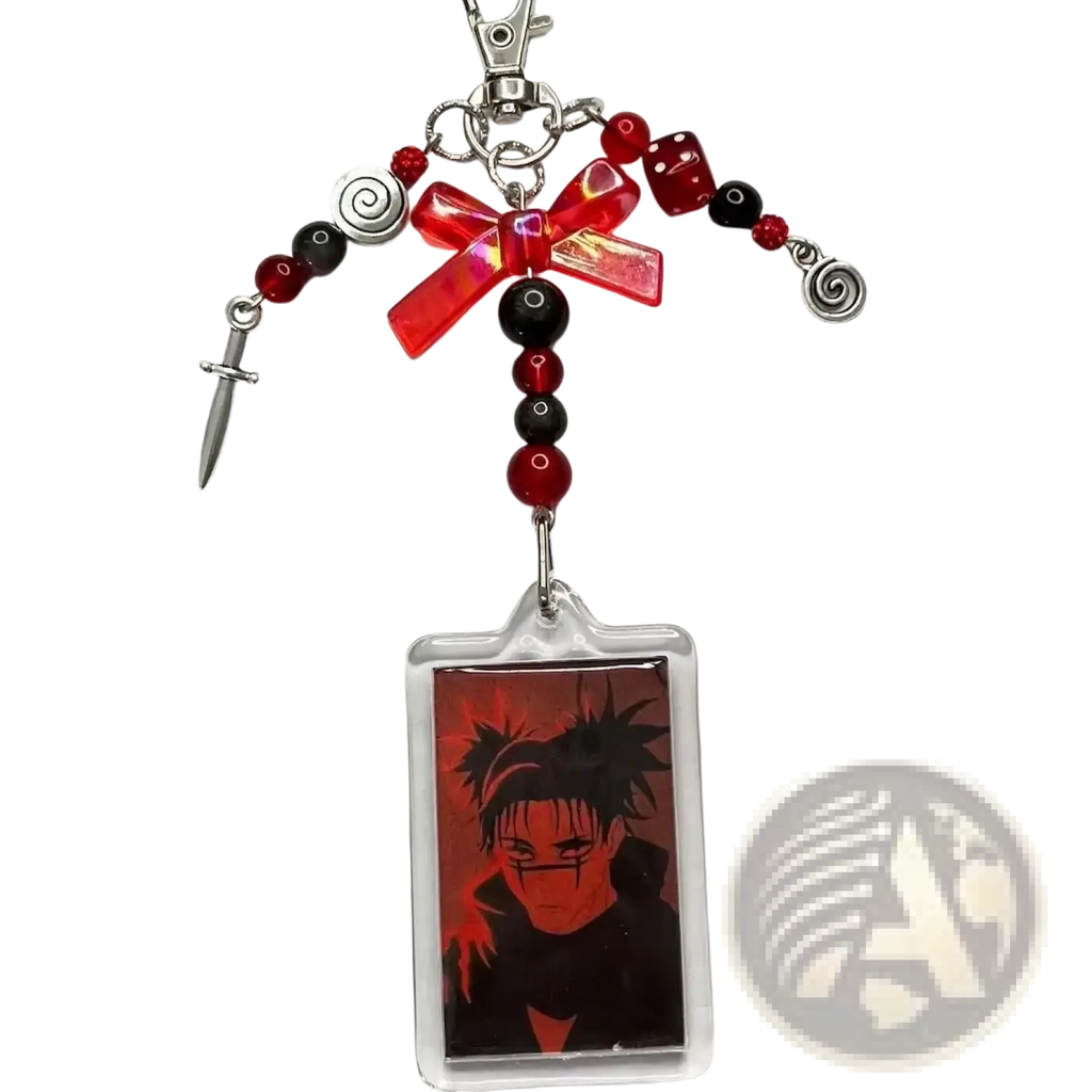 Anime beaded y2k acrylic keychain featuring red and black beads, translucent red bow, silver spiral charms, dice, dagger, and anime portrait