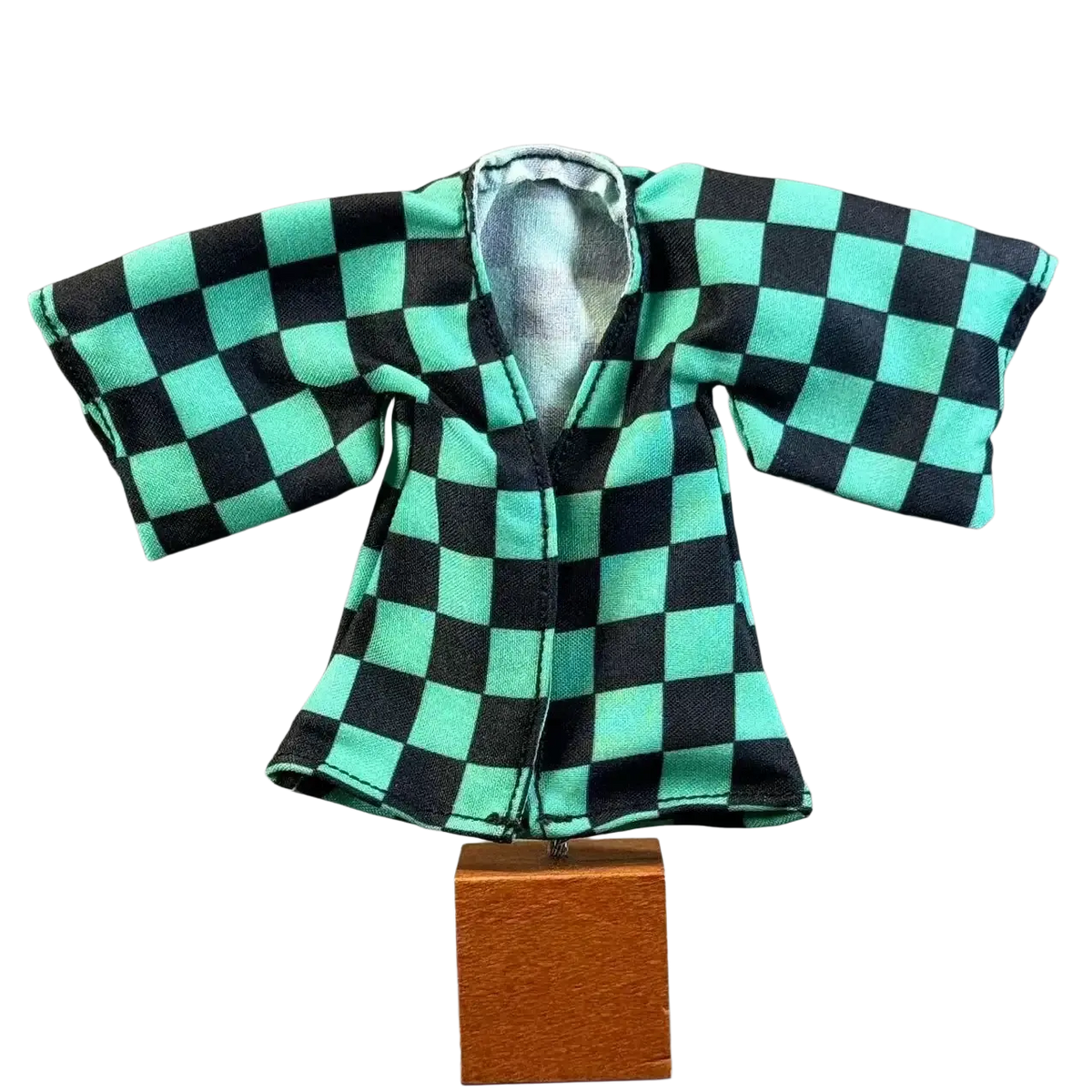 Miniature black and teal checkered anime Kamado Tanjirou kimono coat with silver-lined interior on wooden stand for 6 inch body