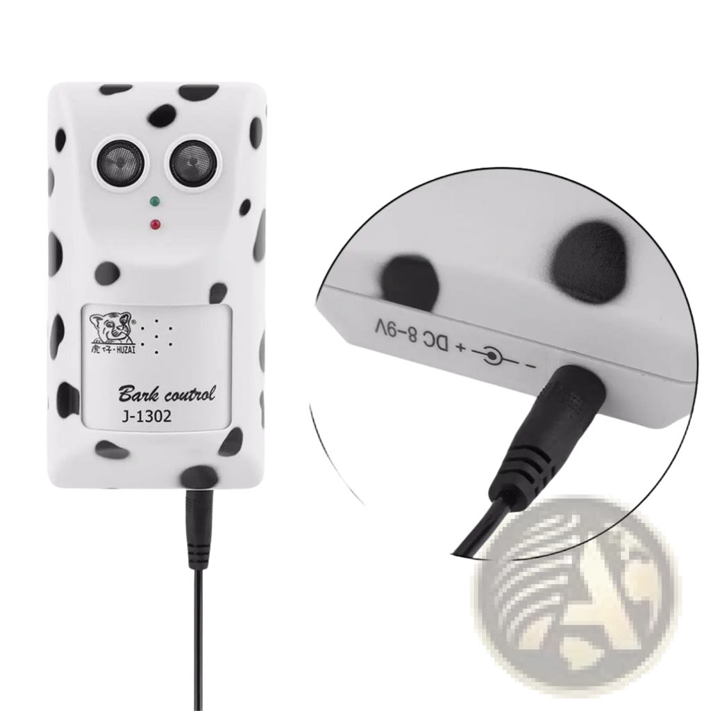 White dalmatian-patterned ultrasonic anti bark device with two circular sensors and black power cable for wall mounting