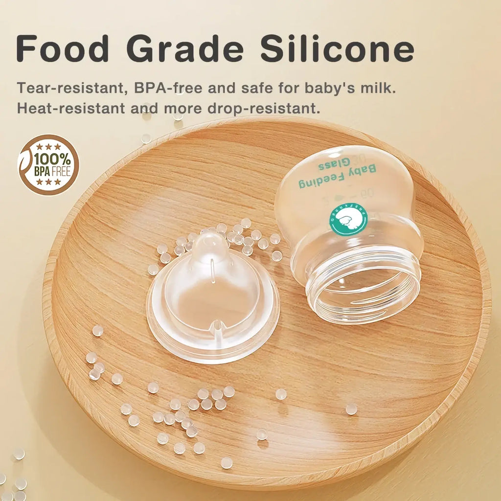 Clear silicone anti-flatulence glass baby bottle with transparent body and green labeling bpa free for feeding