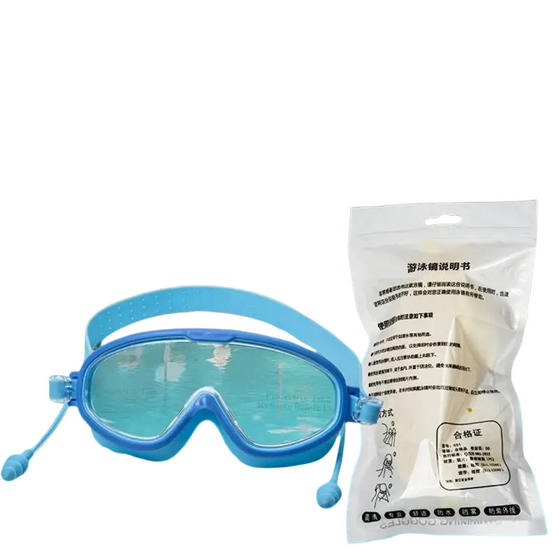 Blue anti-fog swimming goggles with large clear lenses and adjustable earpieces packaged in a white plastic bag