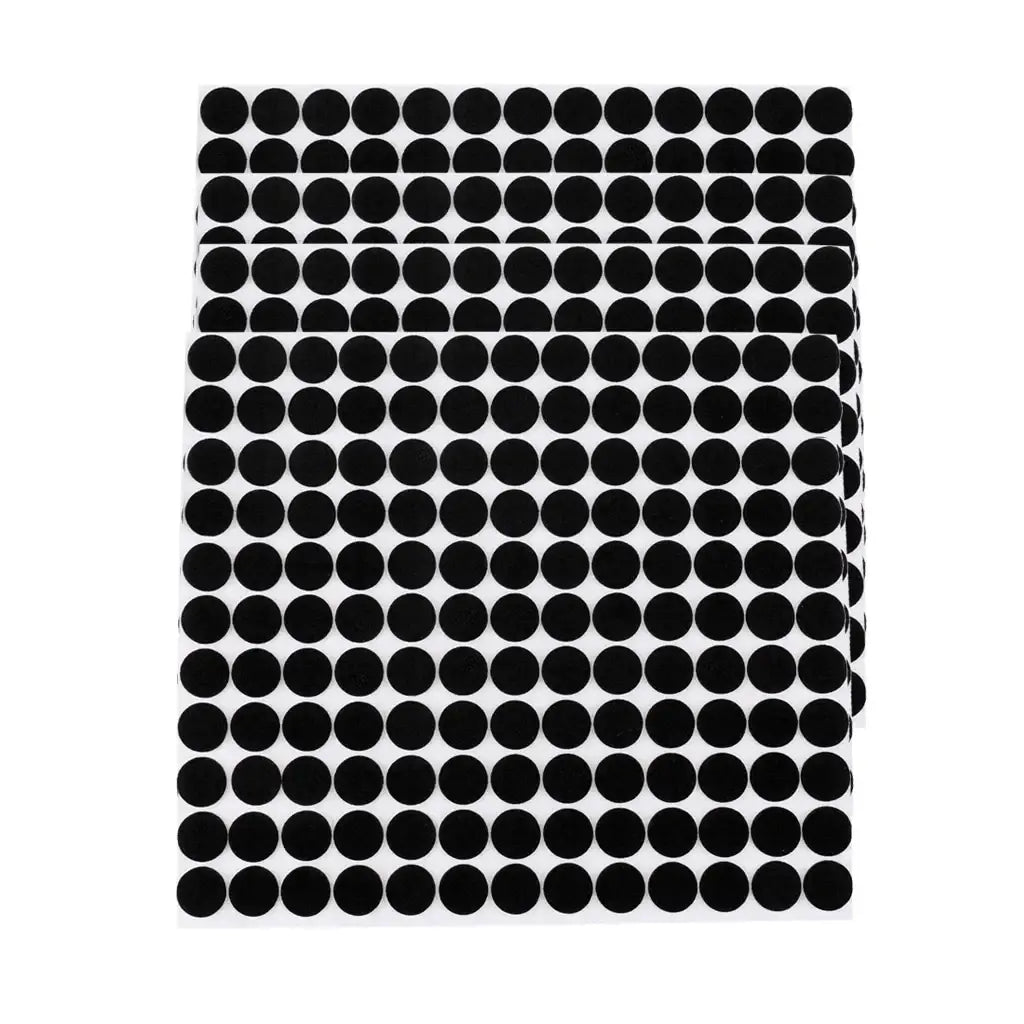 Black circular adhesive anti scratch rubber furniture pads arranged in neat rows on five white sheets