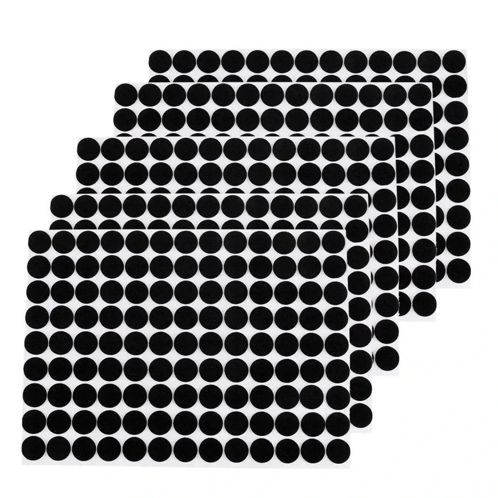 Black circular adhesive rubber furniture pads on white sheets for anti scratch protection five sheets included