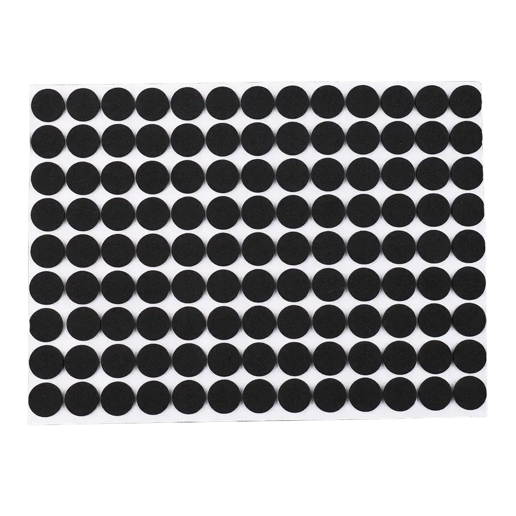 Black circular adhesive anti scratch rubber furniture pads arranged in neat rows on white backing sheet