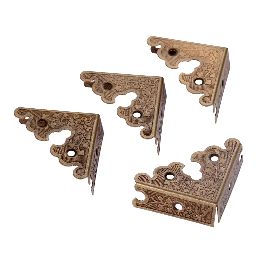 Antique bronze decorative corner brackets in brass with floral engravings and scalloped edges for furniture protector