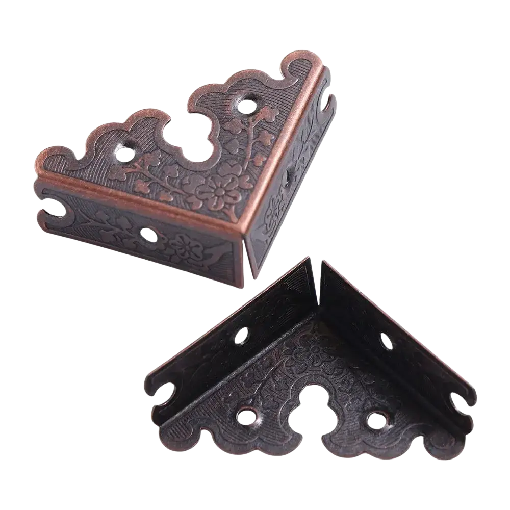 Antique bronze decorative corner brackets with intricate floral embossing and scalloped edges as furniture protector