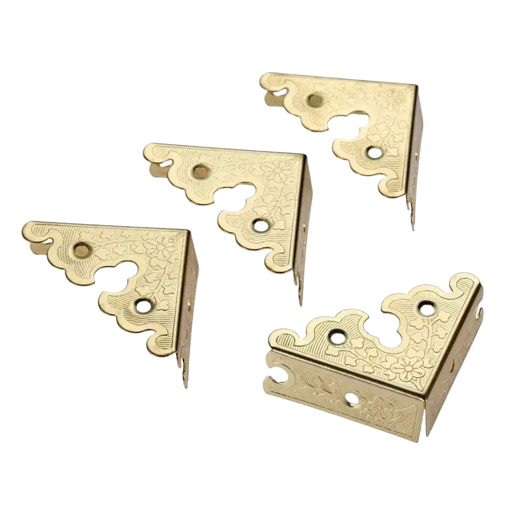 Antique bronze decorative corner brackets in gold with ornate floral engravings and scalloped edges furniture protector