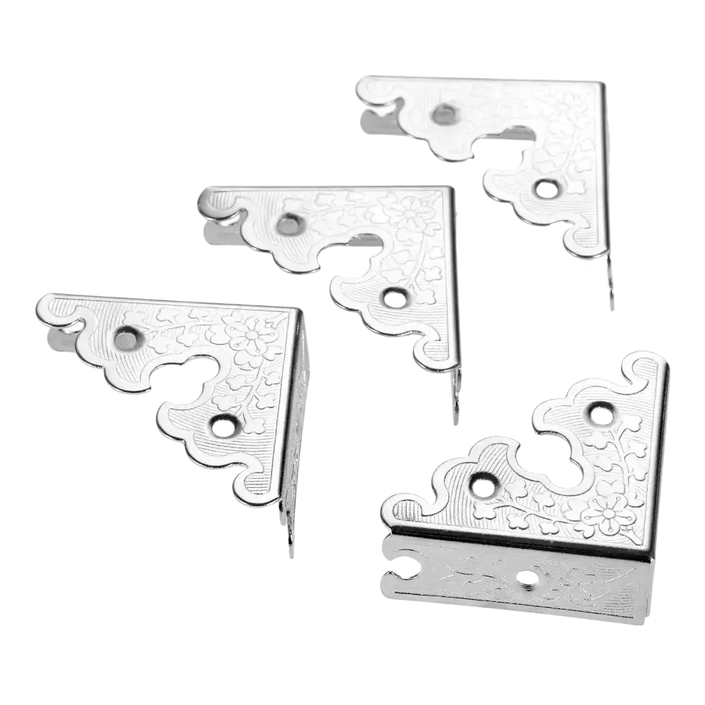 Antique bronze decorative corner brackets in silver metal with intricate floral engravings and scalloped edges furniture protector