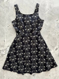 Black sleeveless a-line skater dress with white botanical and mushroom apothecary print for casual wear