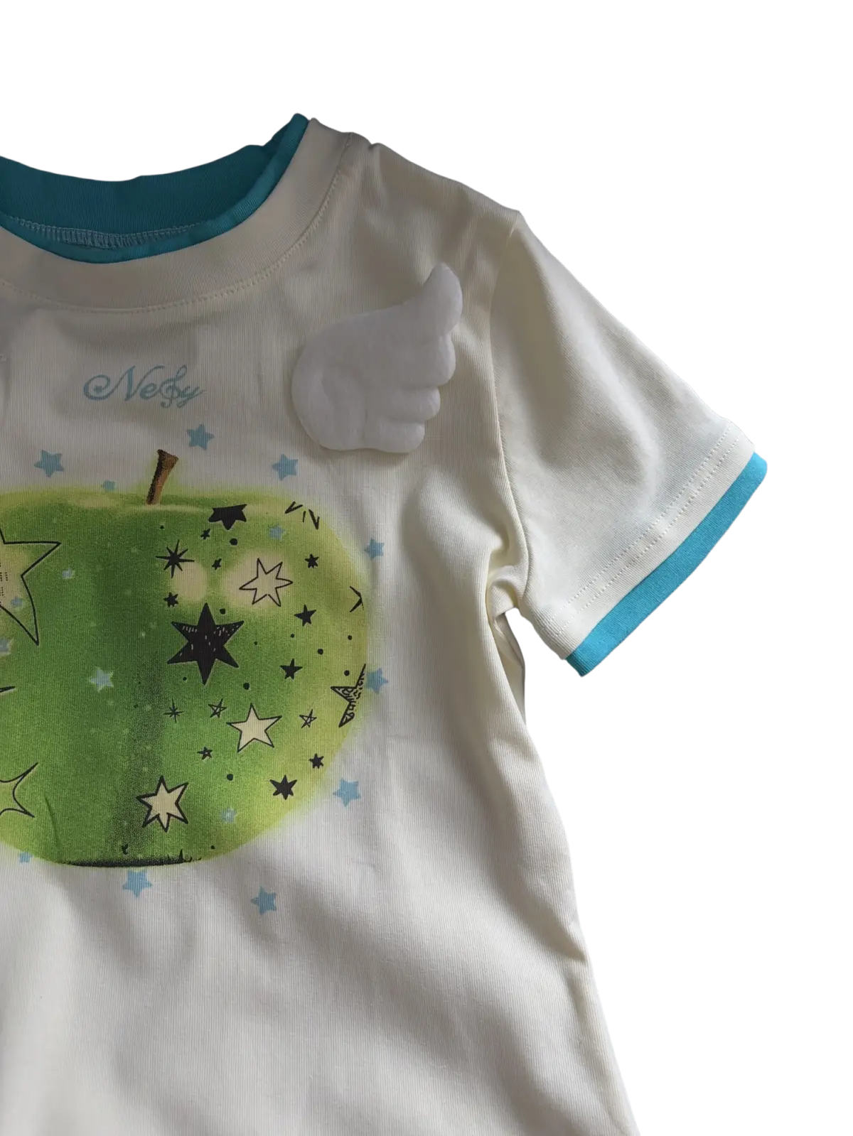 White cotton round neck t-shirt with teal trim and green apple print featuring black beige and light blue stars