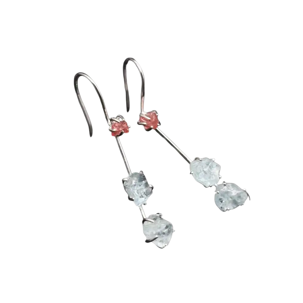 A pair of aquamarine spinel silver drop earrings with silver hooks, pink gemstones, and clear faceted stones below