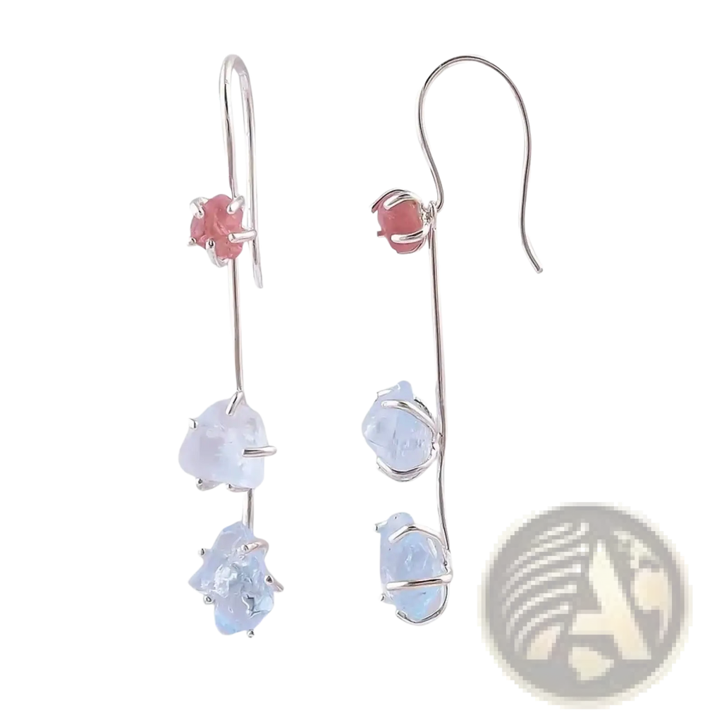 Silver drop earrings featuring a pink spinel gemstone and two light blue raw aquamarine stones below