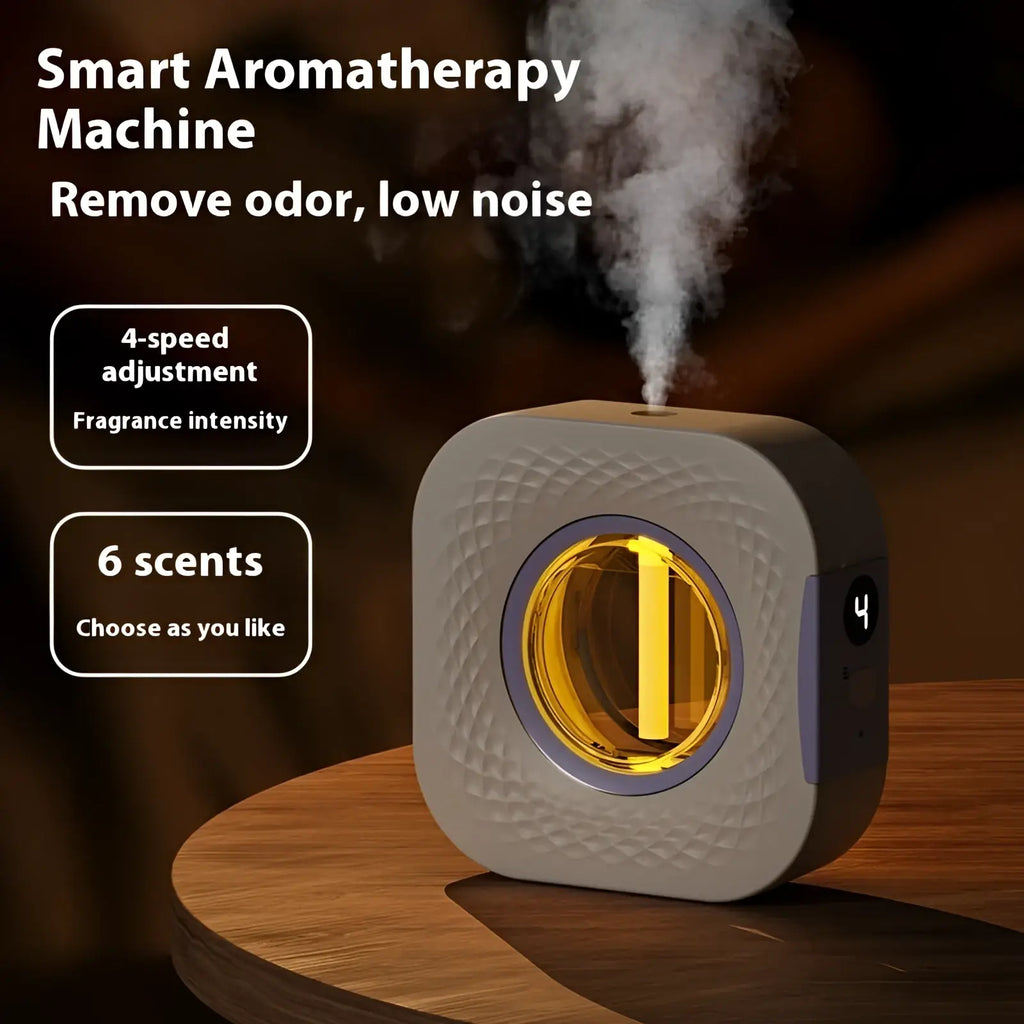A sleek square-shaped smart rechargeable wall mounted aroma diffuser with textured gray body and glowing yellow light
