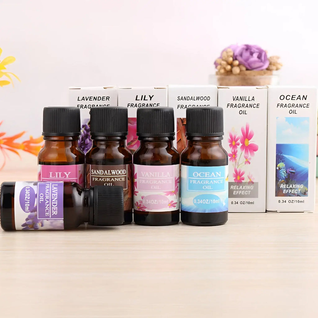 Set of five amber glass aromatherapy essential oil bottles with black caps and colorful fragrance labels for humidifiers