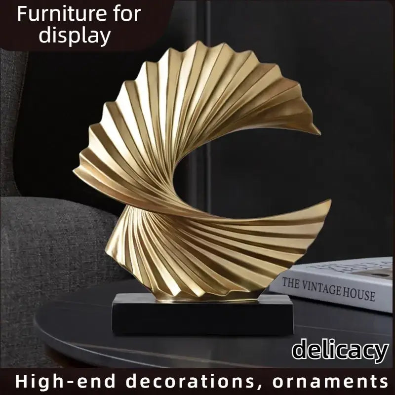 Art deco gold wave sculpture tabletop decor featuring a golden metallic fan-like spiral design on a black base