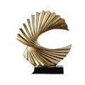 Art deco gold wave sculpture tabletop decor featuring a glossy gold sculpted shell shape with radial ridges