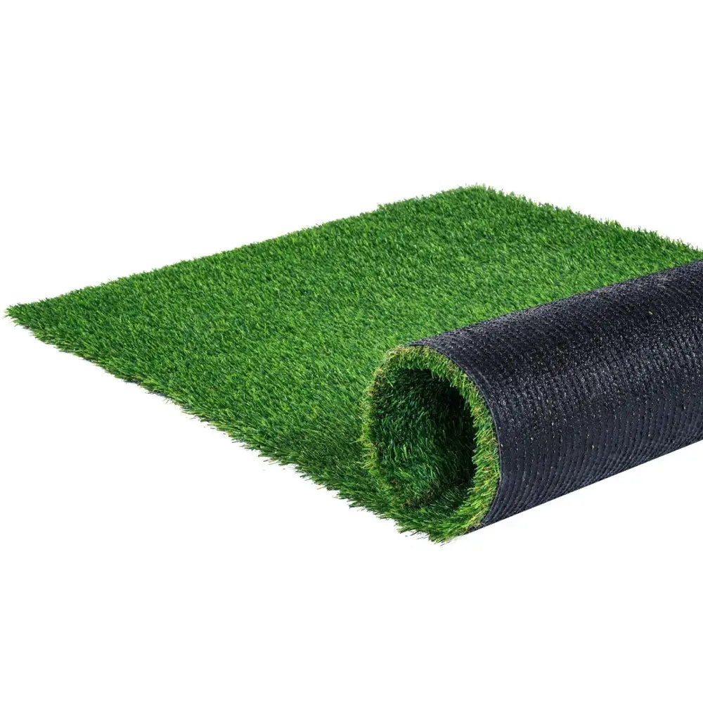 Green artificial grass turf rug 4x6 ft with drainage feature and black backing partially rolled to show textured fibers