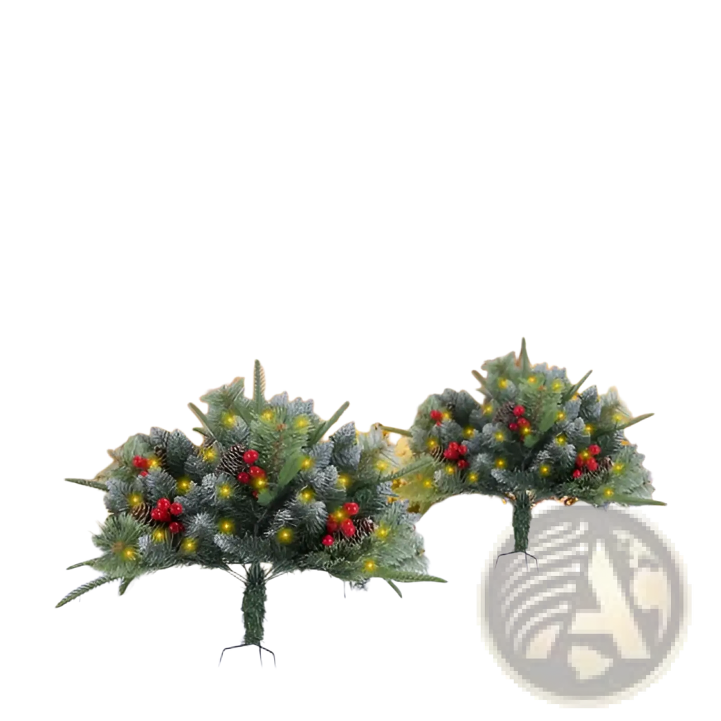 Two artificial Christmas trees with green pine-like foliage red berries and warm yellow LED lights for holiday decor