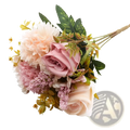 A delicate artificial flower rose wedding bouquet with soft pink and peach petals and realistic green foliage