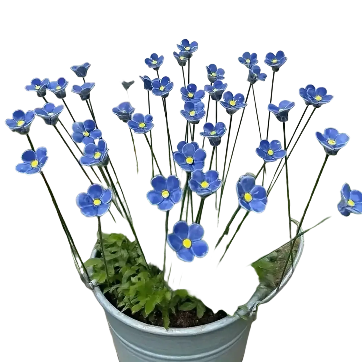 Blue ceramic artificial flowers of forget me nots with yellow centers arranged in a galvanized metal bucket for decorating vases