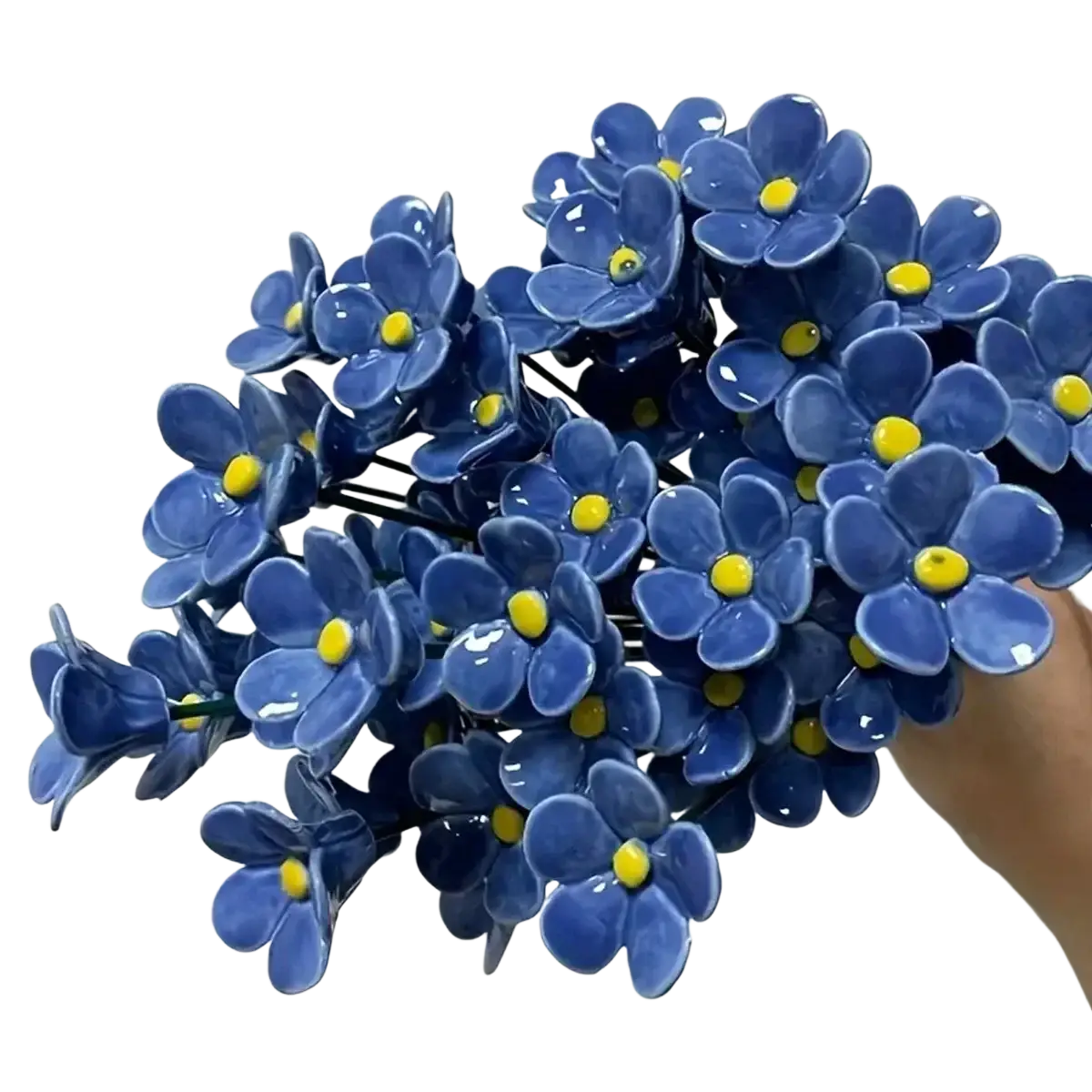 A cluster of glossy blue ceramic artificial flowers with yellow centers ideal for decorating vases
