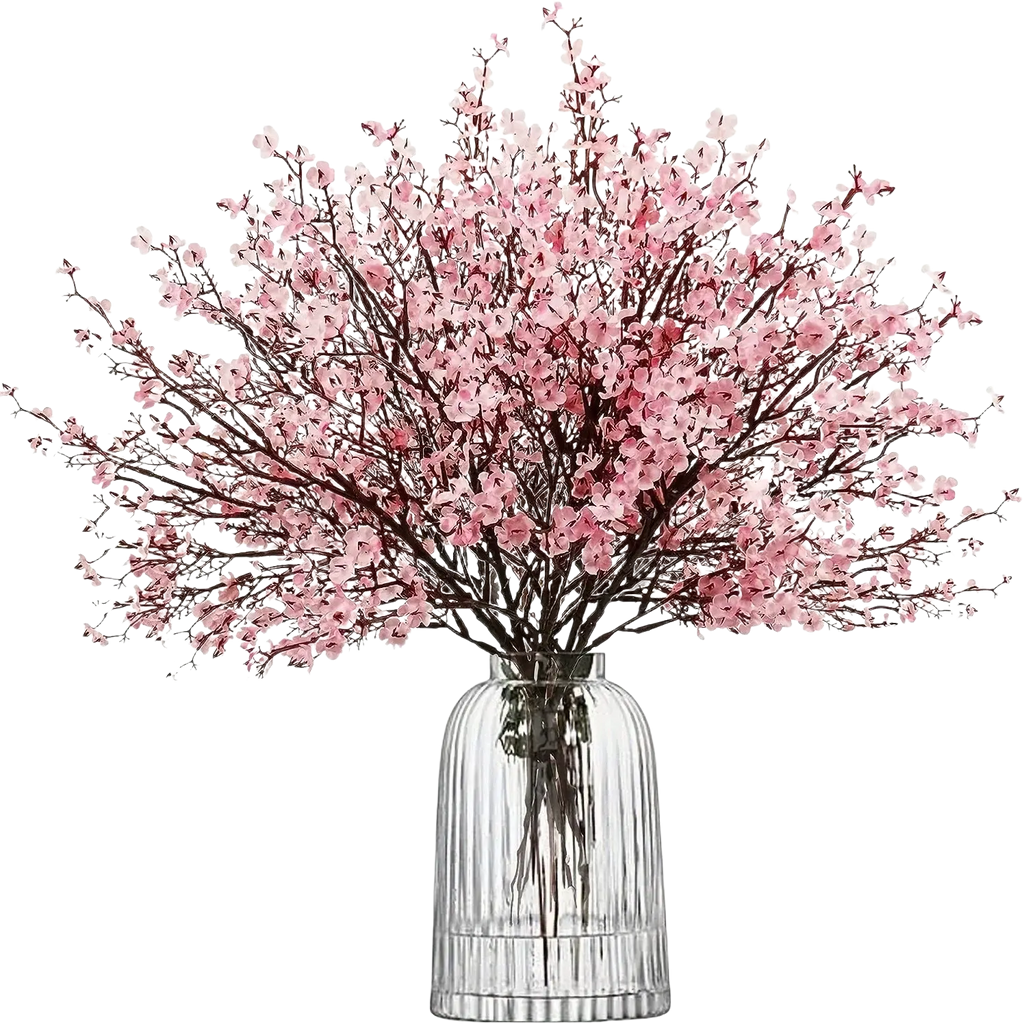 A delicate pink artificial flowers cherry blossoms bouquet arranged in a clear ribbed glass vase