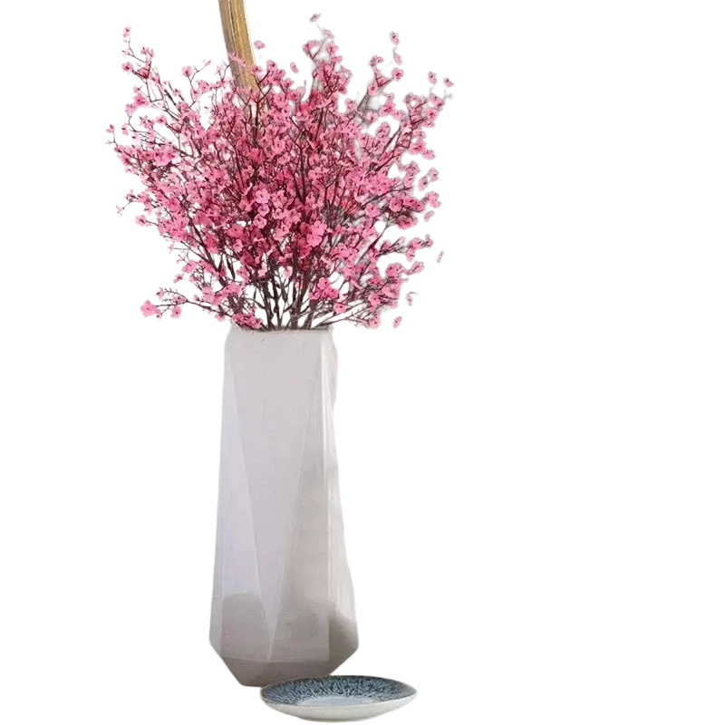 A sleek white ceramic vase holding a vibrant pink artificial flowers cherry blossoms bouquet arranged elegantly