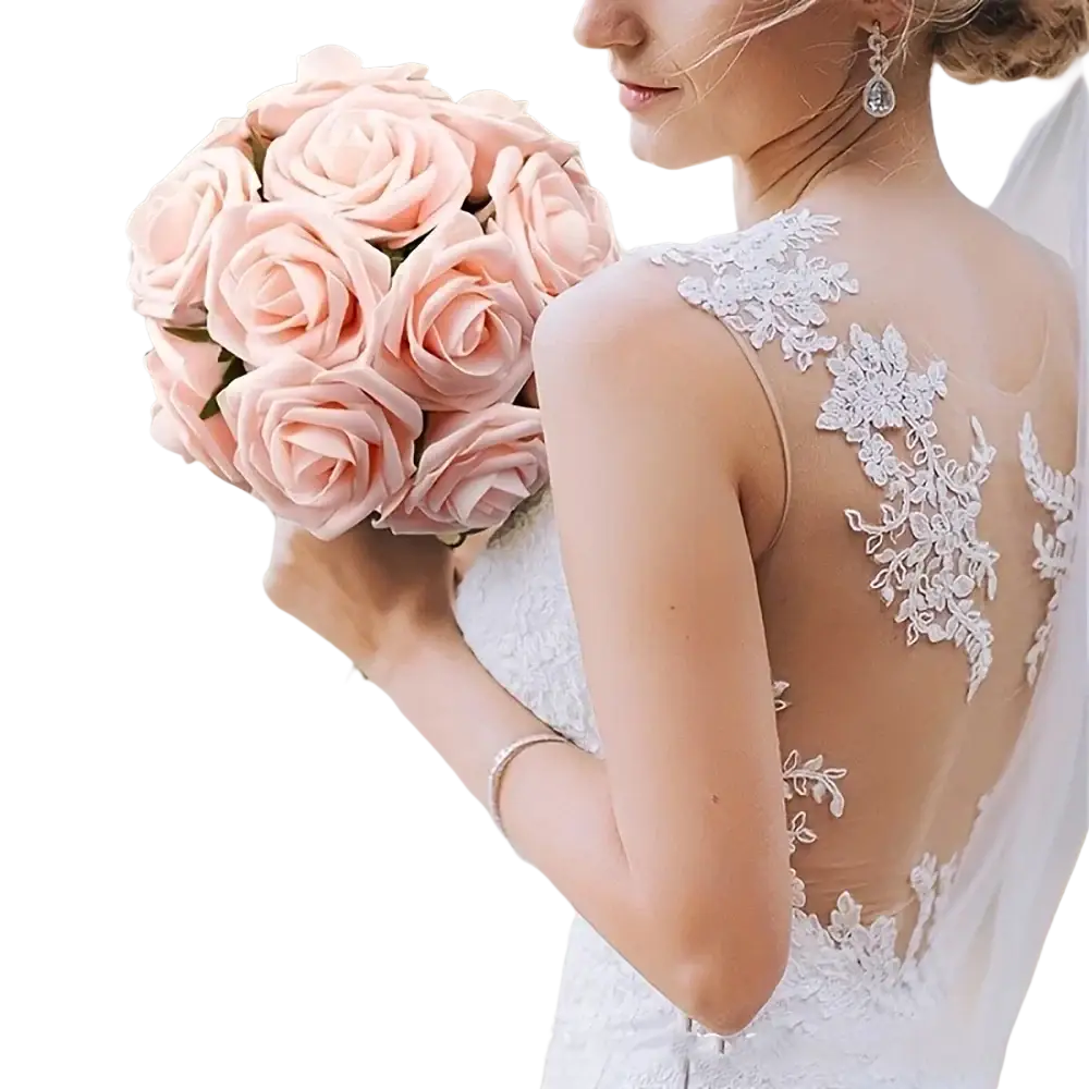 A bouquet of soft pink artificial flowers roses with stems held by a bride in a white lace wedding gown for decor