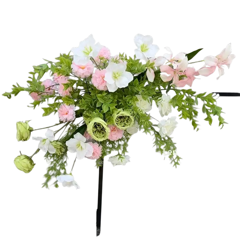 A delicate artificial flowers wedding arch backdrop with soft pink and white blossoms and lush green foliage