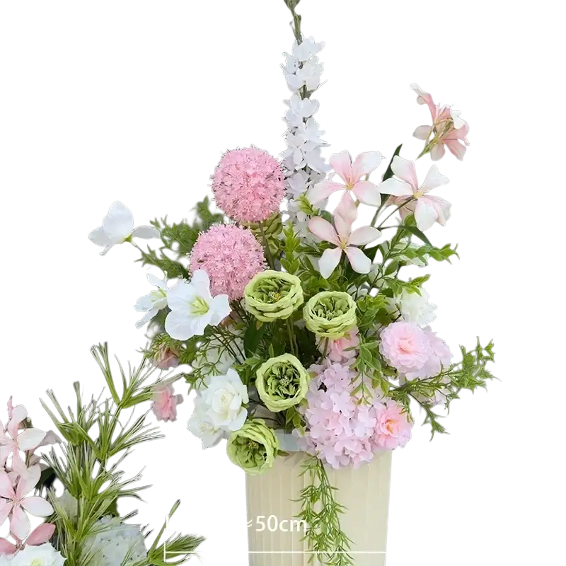 Delicate artificial flowers in soft pink white and green arranged in a cream vase for wedding arch floral backdrop