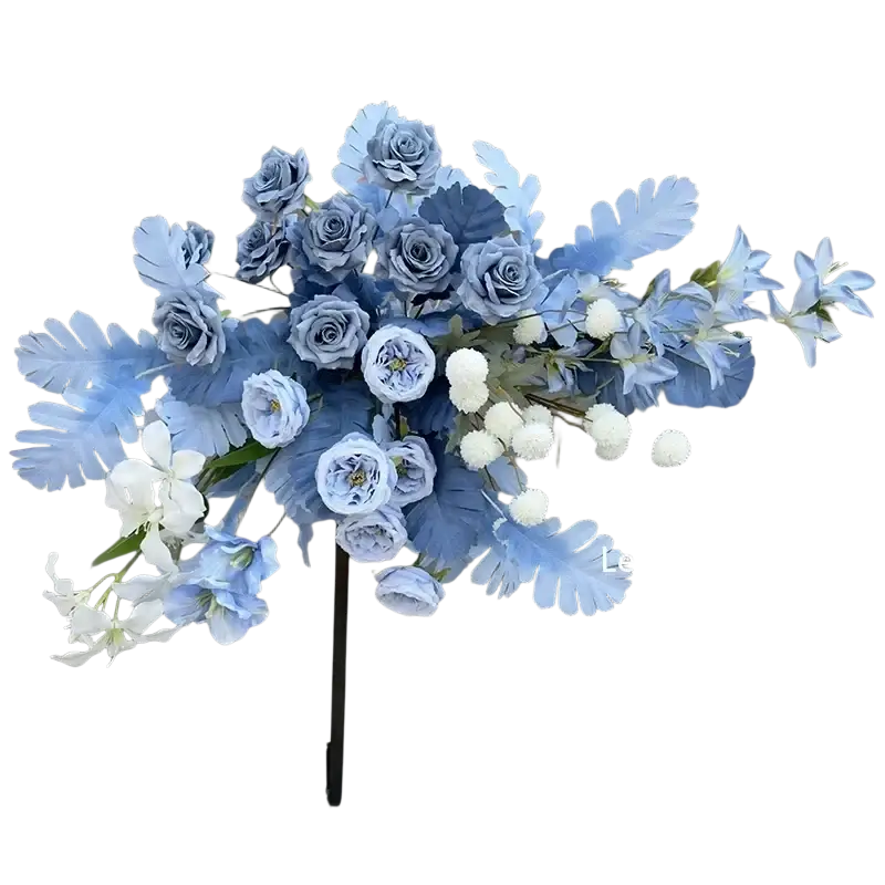 A delicate arrangement of artificial flowers including blue roses and white lilies on a black stand for wedding arch backdrop