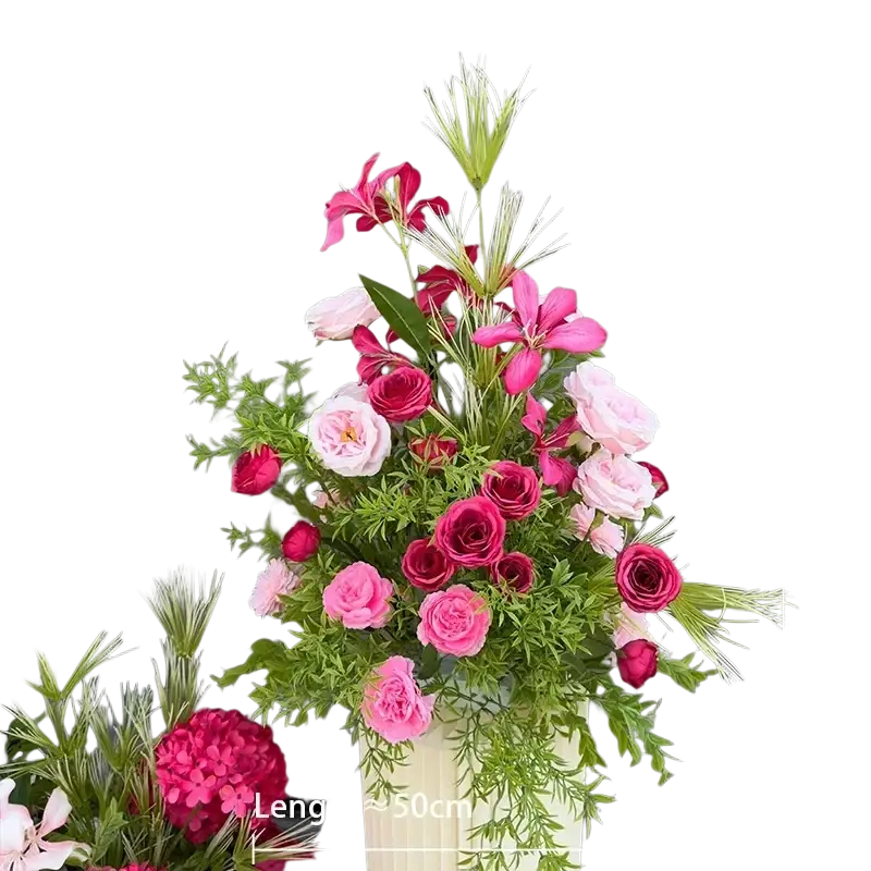 A vibrant artificial flowers wedding arch floral backdrop featuring pink and deep red roses in a cream vase