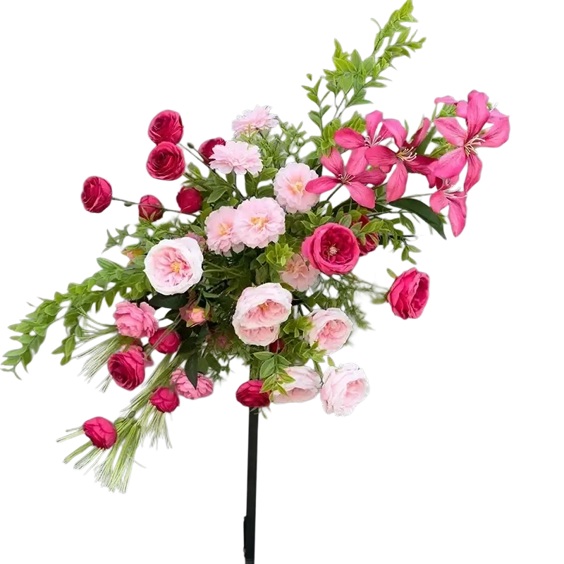 A vibrant artificial flowers wedding arch featuring pink and red roses with white blossoms and green foliage