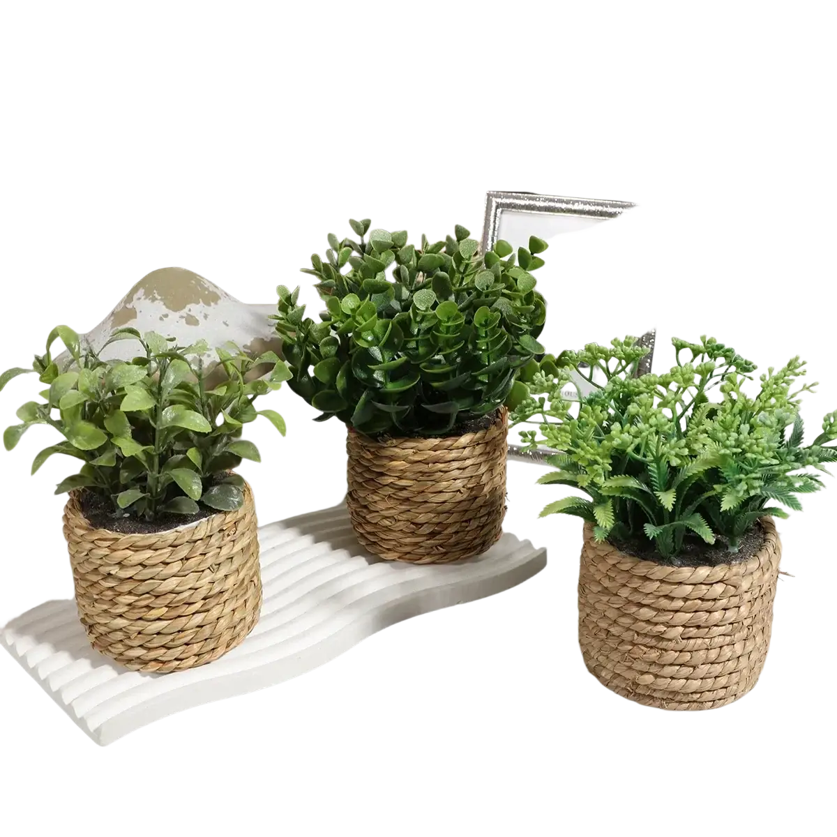 Three small potted artificial plants featuring green eucalyptus flowers in woven natural fiber pots with distinct leaves