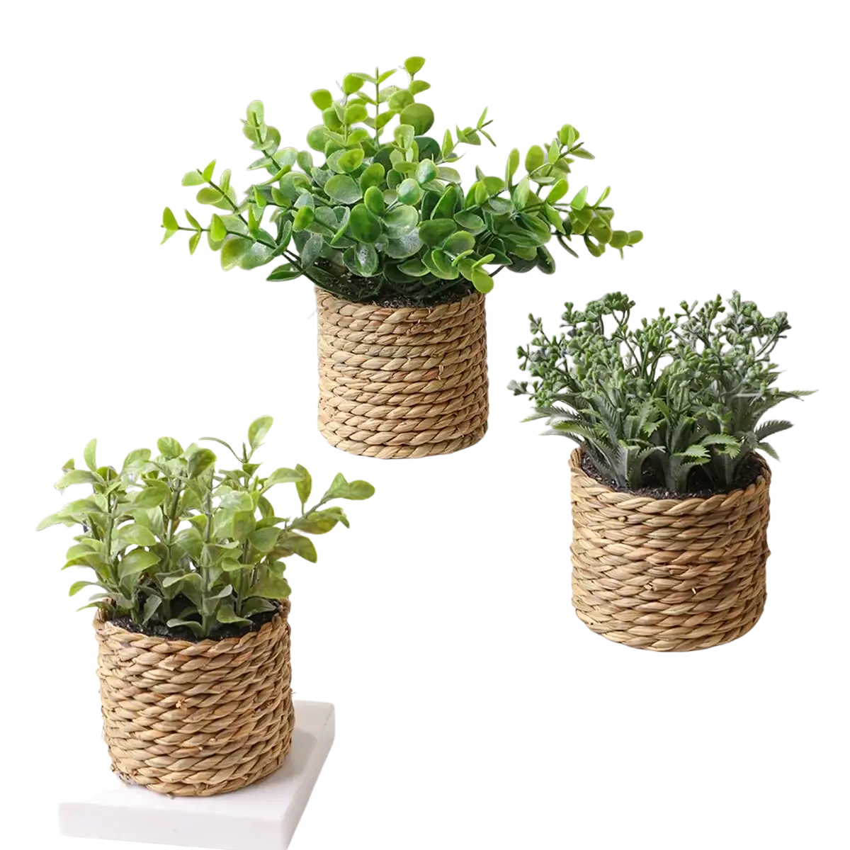 Three woven natural fiber planters with small potted artificial plants featuring eucalyptus flowers and varied green foliage