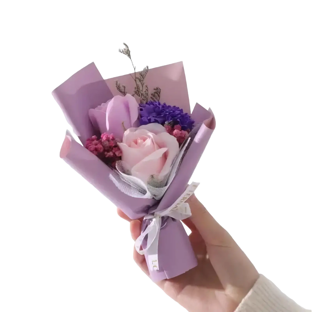 Artificial rose flower bouquet featuring a soft pink rose, purple hydrangea, and pink fillers wrapped in lavender