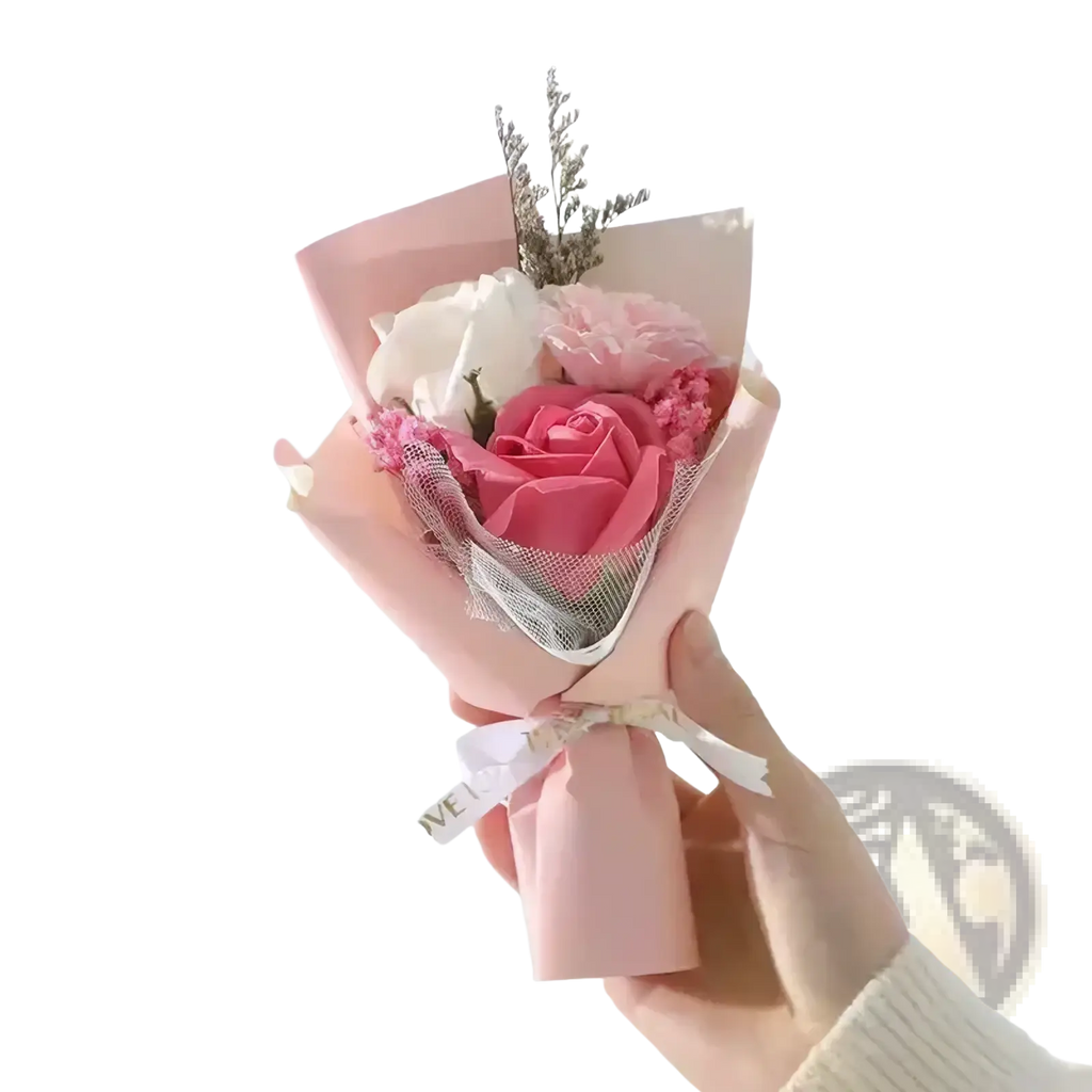 Artificial rose flower bouquet with delicate pink and white soap roses wrapped in pastel paper with sheer mesh accent