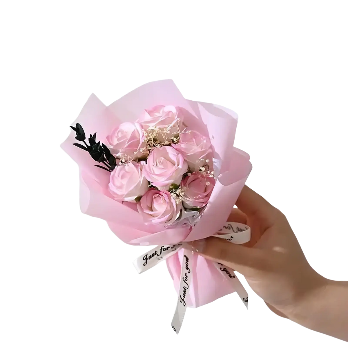 A delicate artificial rose flower bouquet with soft pink preserved roses wrapped in translucent paper for gifts