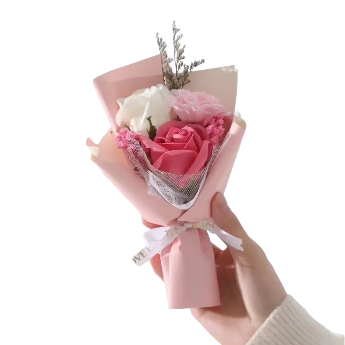 Artificial rose flower bouquet with pink white and blush soap roses and dried foliage wrapped in pale pink paper