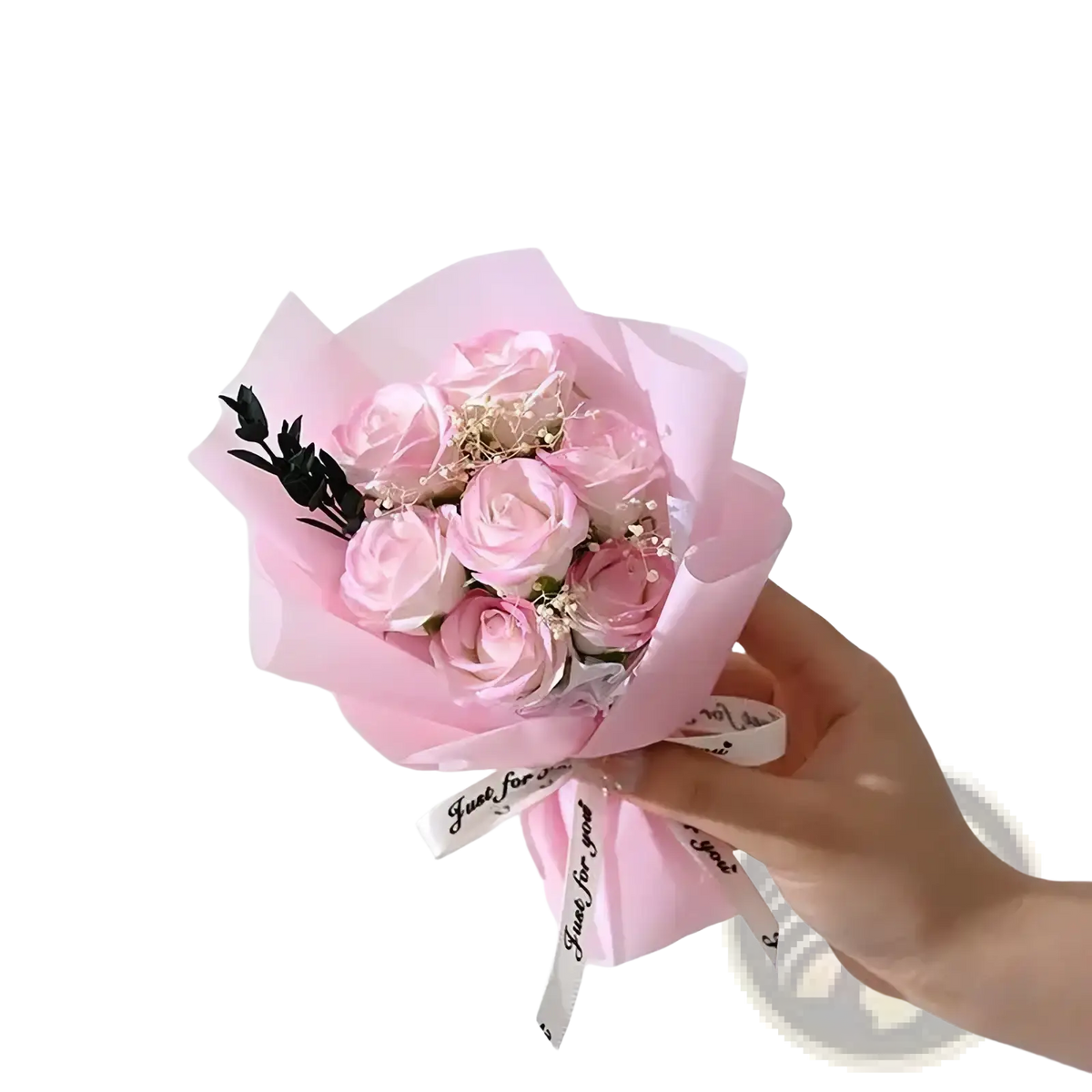 A delicate artificial rose flower bouquet with soft pink preserved roses wrapped in translucent paper for gifts