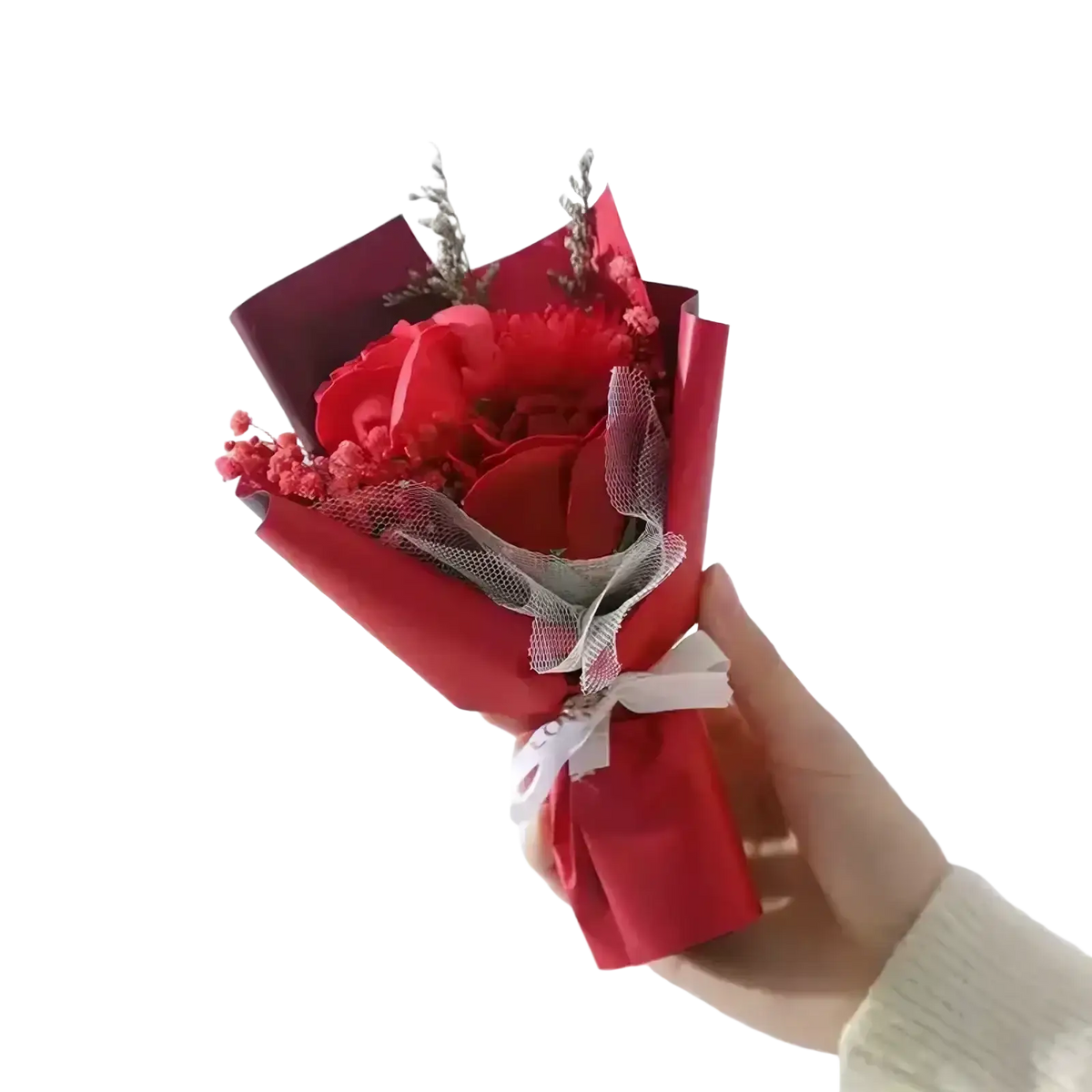 A vibrant red artificial rose flower bouquet wrapped in matching paper with white ribbon and sheer mesh accents