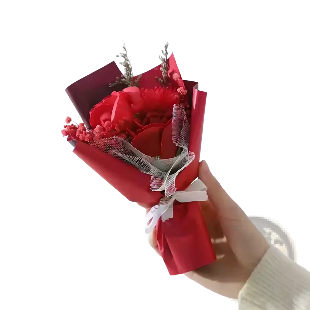 Artificial rose flower bouquet featuring vibrant red roses wrapped in matching paper and tied with white ribbon for gifts