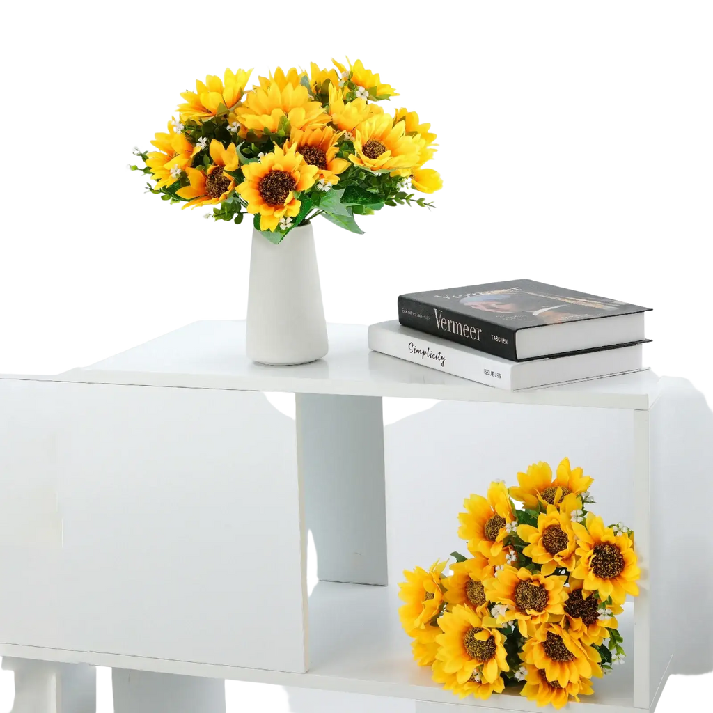 A vibrant artificial sunflower bouquet with bright yellow petals and dark centers in a white ceramic vase