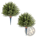 Two artificial topiary cypress trees 16 inch with dense green foliage and brown trunks on dark blue metal spikes