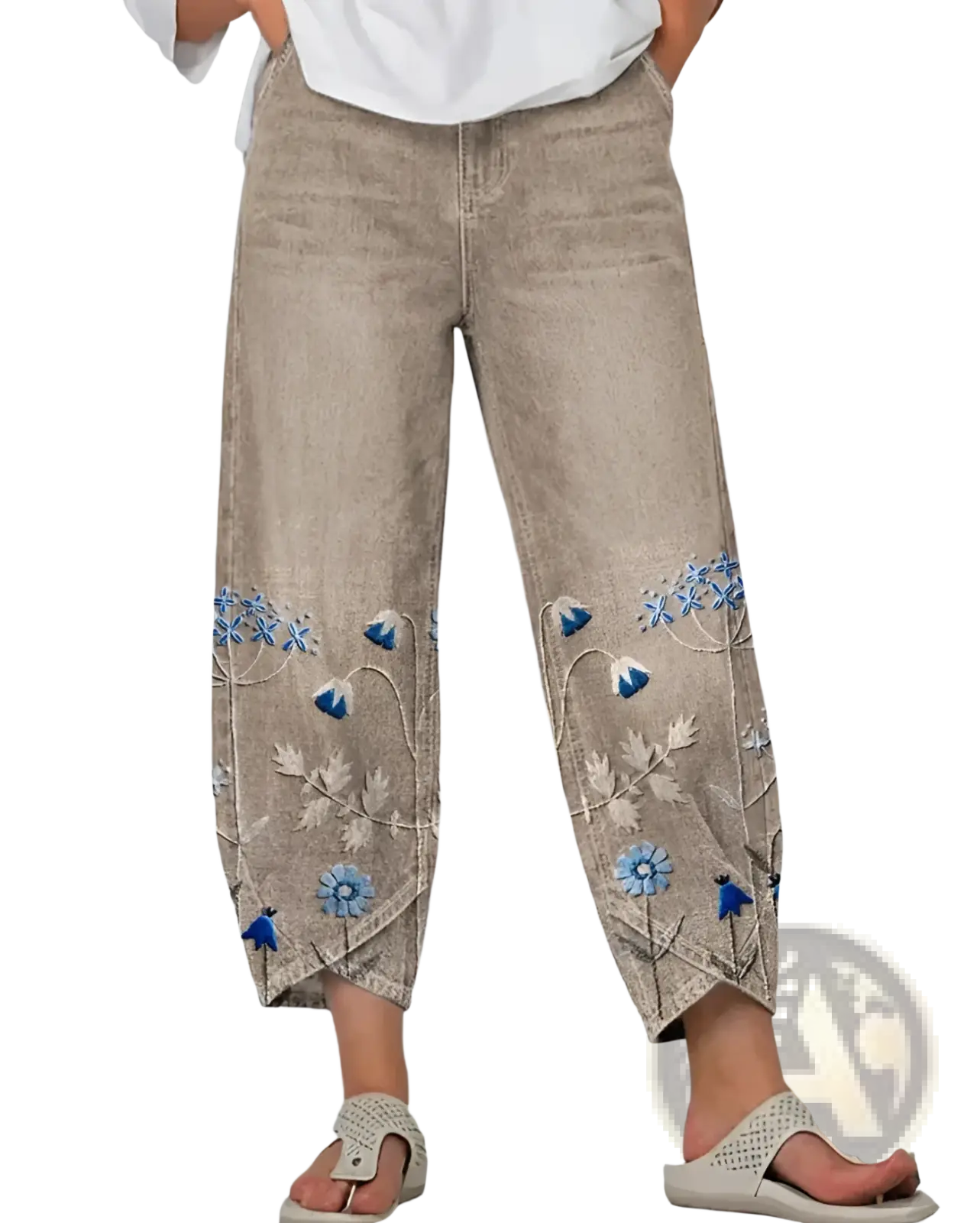 Beige denim slimming cropped pants with blue and white floral embroidery on lower legs featuring artistic print