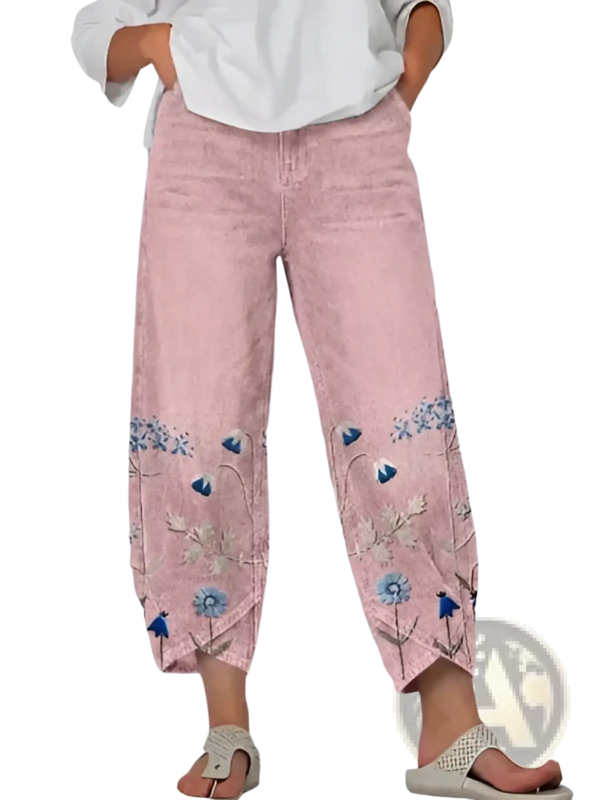 Pink denim slimming cropped pants featuring blue floral embroidery along the lower legs for artistic style