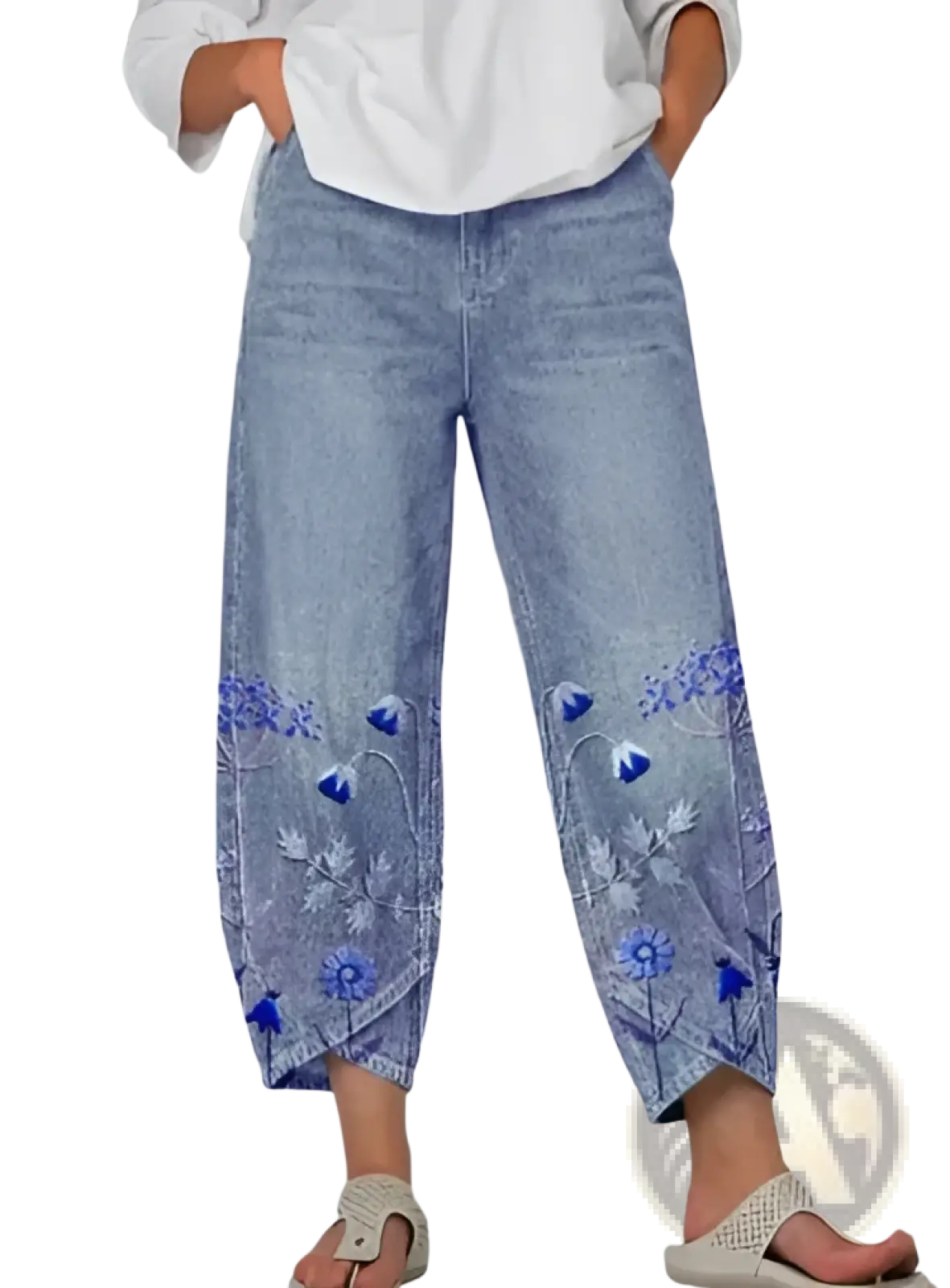 Light-wash denim slimming cropped pants with intricate blue floral embroidery along the lower legs