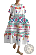 Artistic printed loose linen maxi dress in white with vibrant geometric tribal patterns and decorative tassels along the hem