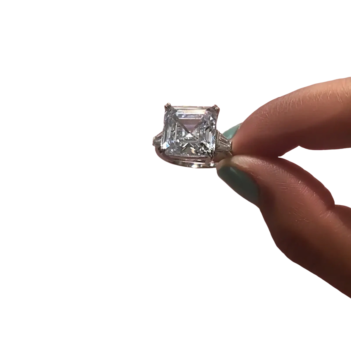 Asscher cut lab diamond sterling silver promise ring with a sparkling emerald cut diamond held between fingers